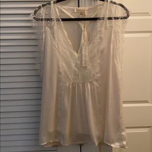 Lace shirt with tank top underneath.